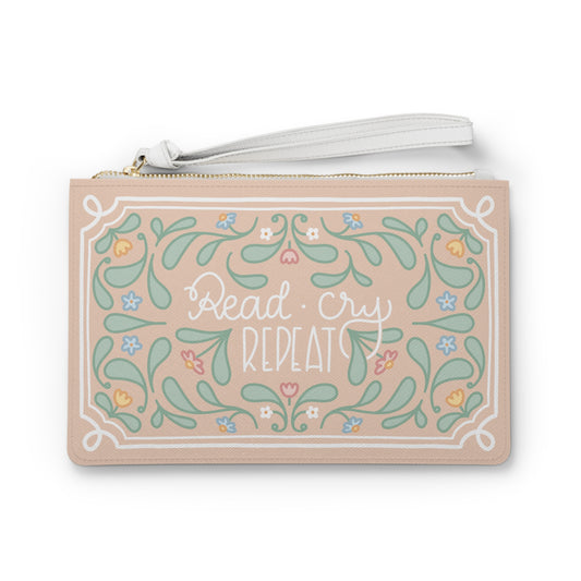 Read Cry Repeat clutch bag | floral folk art pattern